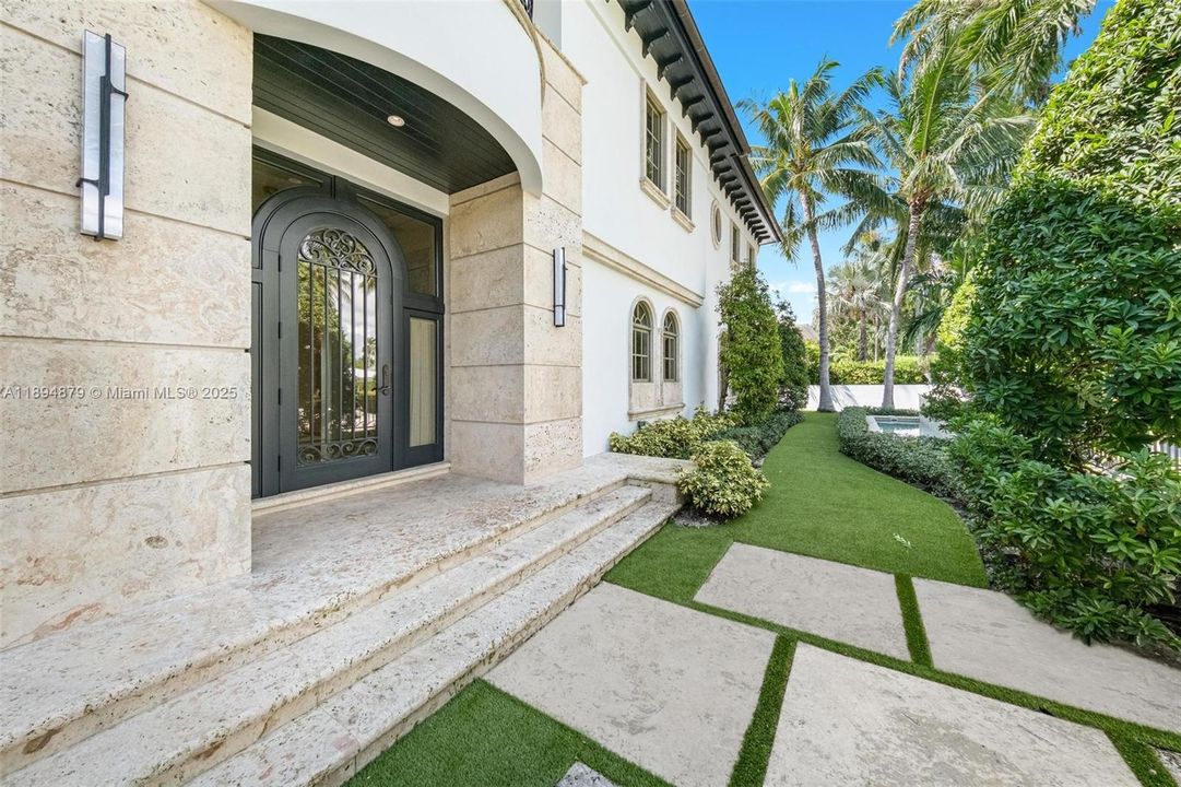 Stone entry porch with arched front door