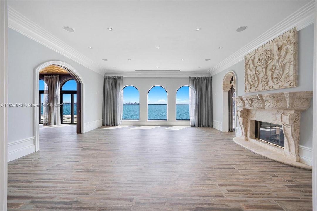 Arched picture windows frame open-bay views in the living room