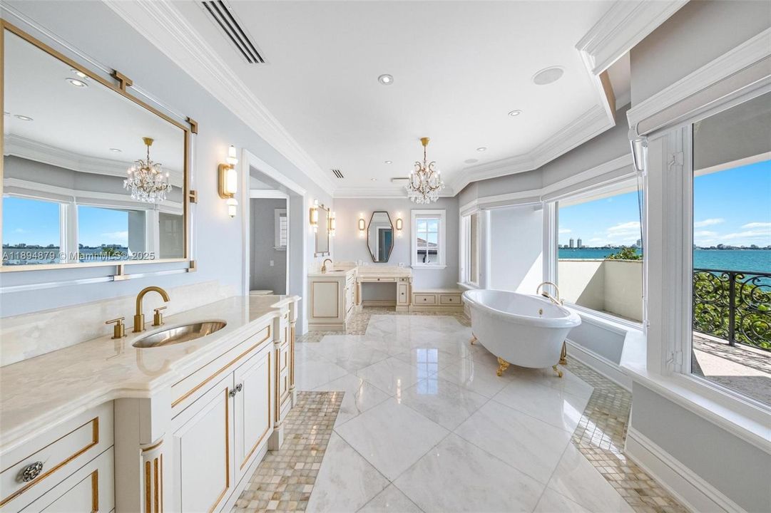 Corner-window primary bath overlooking the bay