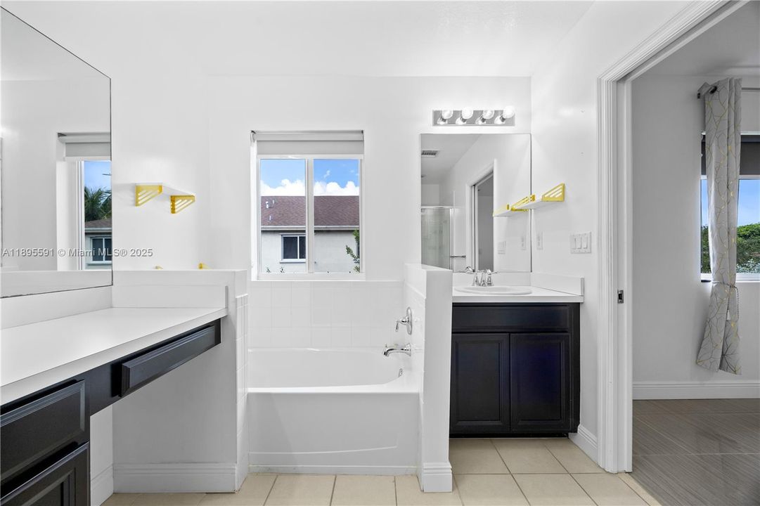 MAIN BATROOM. BATHTUB, DUAL SINKS , STANDING SHOWER