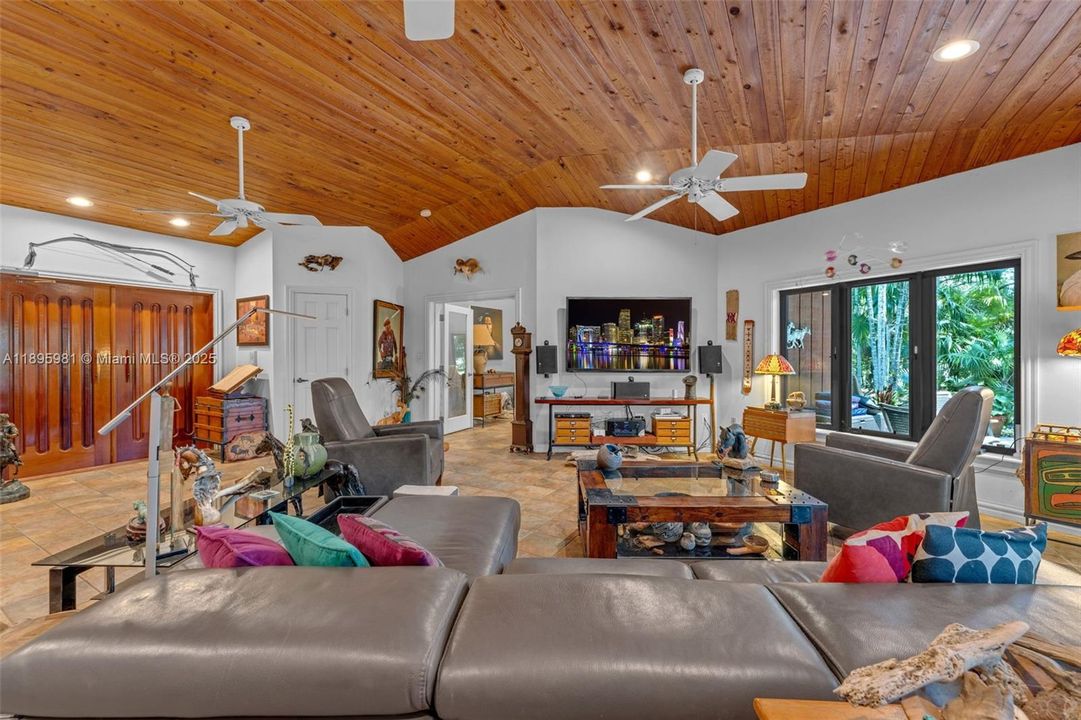 LOOKING BACK TO ENTRANCE. THE HOME IS DESIGNED TO BRING THE OUTSIDE IN WITH THE USAGE OF ORGANIC MATERIALS, SLATE FLOORS, MOHAGANY DOORS, CYPRESS CEILINGS, FIR EXTERIOR WITH LARGE GLASS  DOORS AND WINDOWS