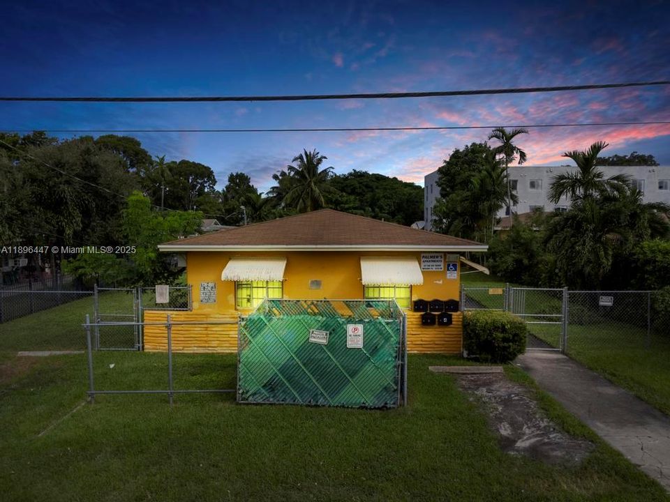 Beautiful twilight view of a Miami fourplex located in Little River, showcasing solid CBS construction and spacious front yard. Perfect income-producing investment property near the Design District and Wynwood.