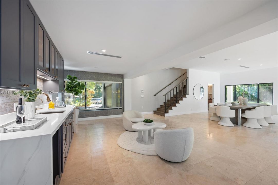 Dining, wet bar, and seating area.