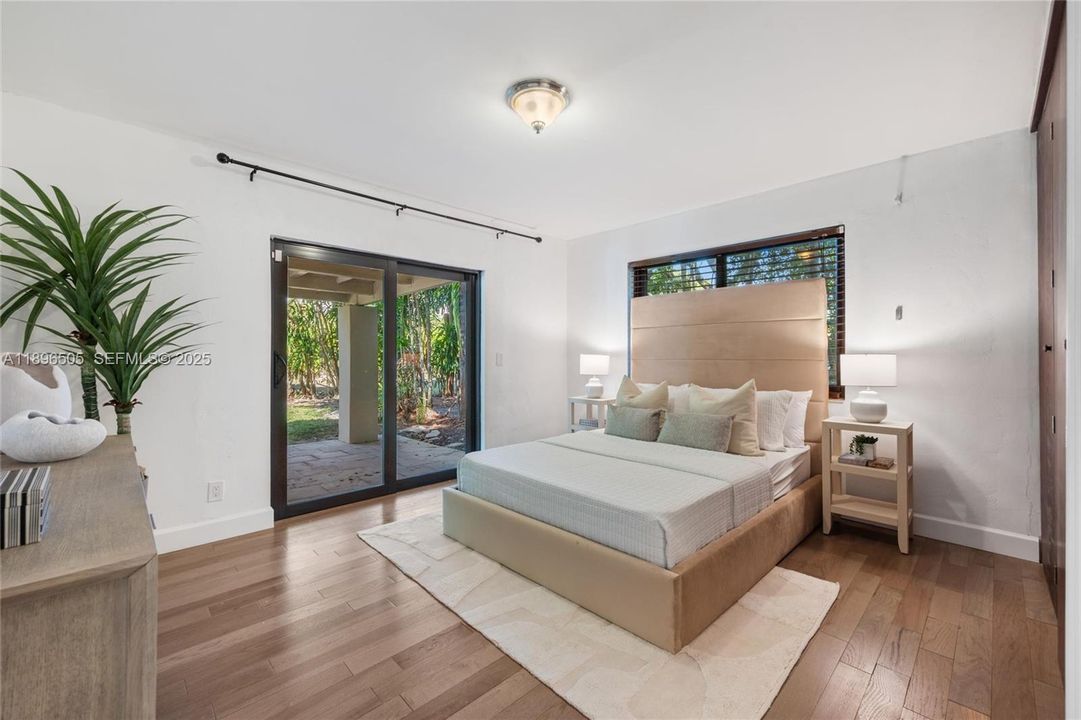 4th bedroom is located on the first floor and opens directly onto a private patio, creating a peaceful indoor-outdoor retreat.