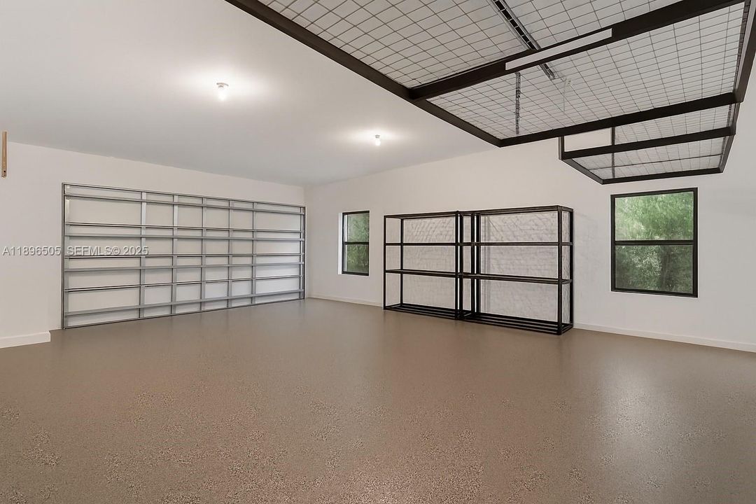 Spacious two-car garage with plenty of additional storage and workspace.