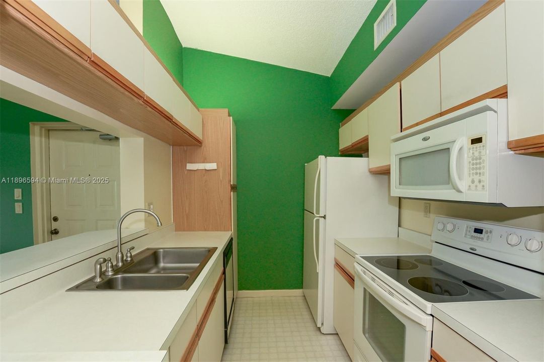 Galley kitchen open to living room and dining room.