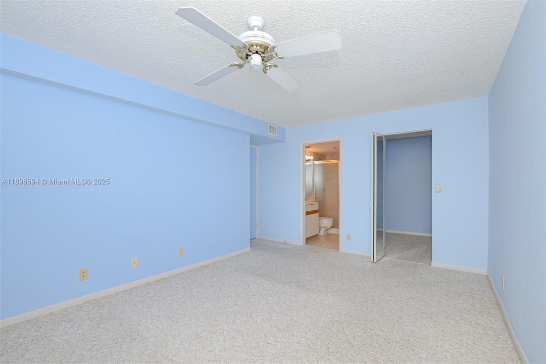 Primary Bedroom with walk in closet, full bath and impact window with River views!