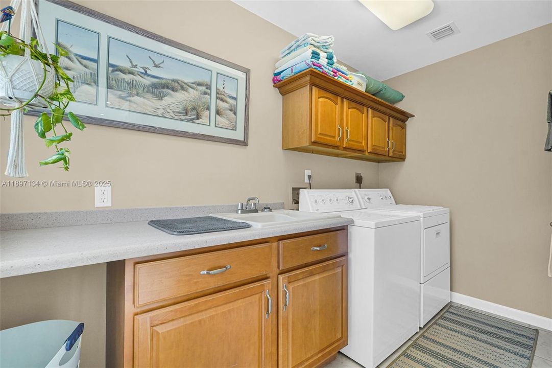 Dedicated laundry room with storage and washer/dryer included.