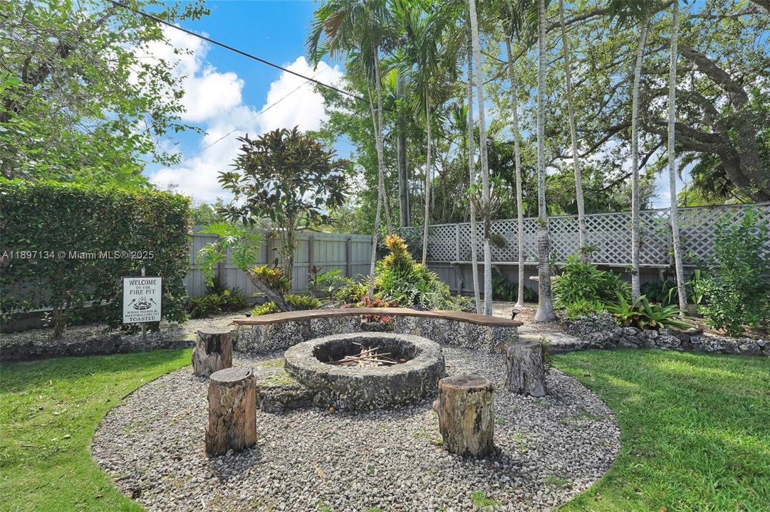 Outdoor firepit and seating area for cozy evenings under the Palmetto Bay sky.