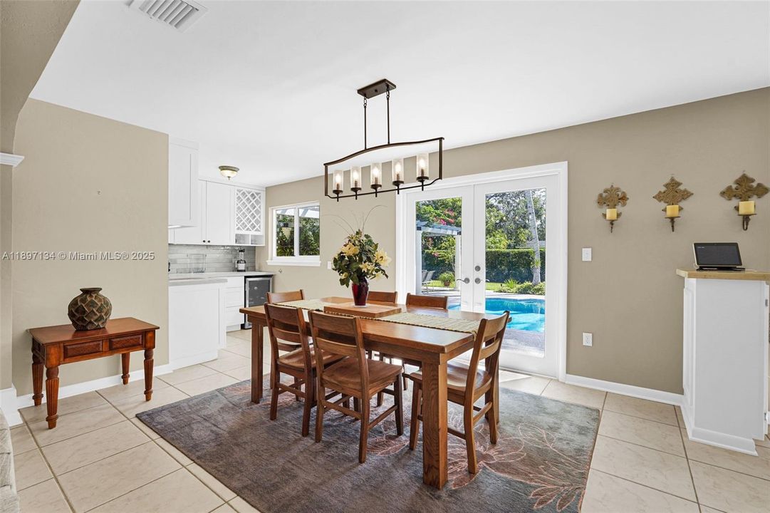 Bright dining area with modern lighting and easy flow to kitchen and living spaces.