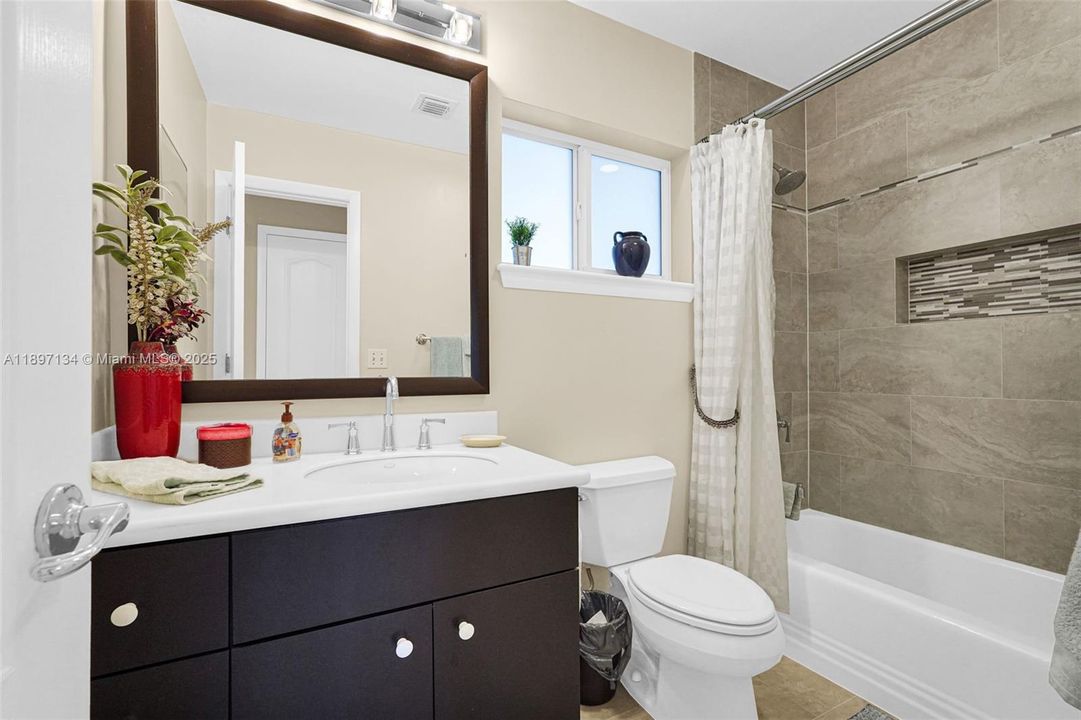 Stylish full bathroom with contemporary finishes and walk-in shower.