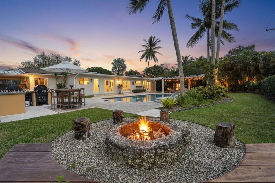 Covered patio with outdoor kitchen and pergola—perfect for year-round entertaining.