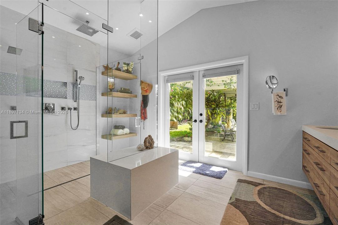 Spa-style bathroom featuring updated fixtures and glass-enclosed shower.