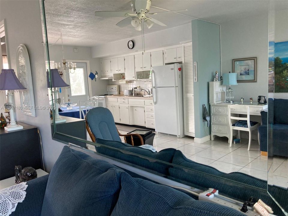 View of kitchen through living room mirror