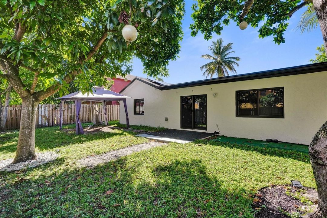 Spacious, fenced back yard with mature trees and shade...