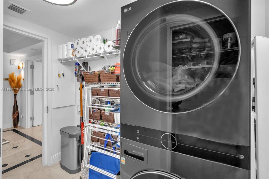 Laundry room with storage + trash chute