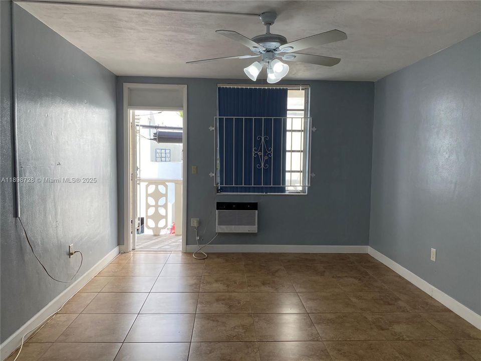 Spacious bedroom with ceiling fan.