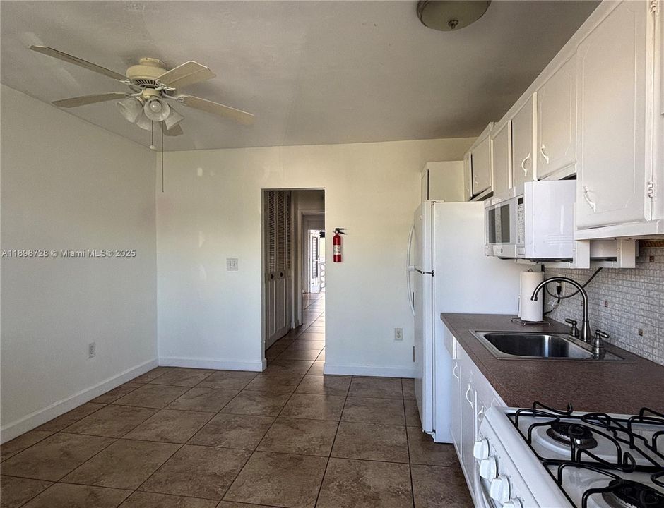 There is a hallway between the living room-kitchen combination. Closet on the left, bathroom on the right.