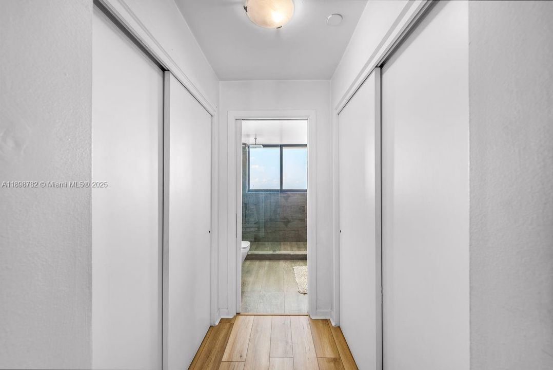 Main bathroom hallway his & hers closet