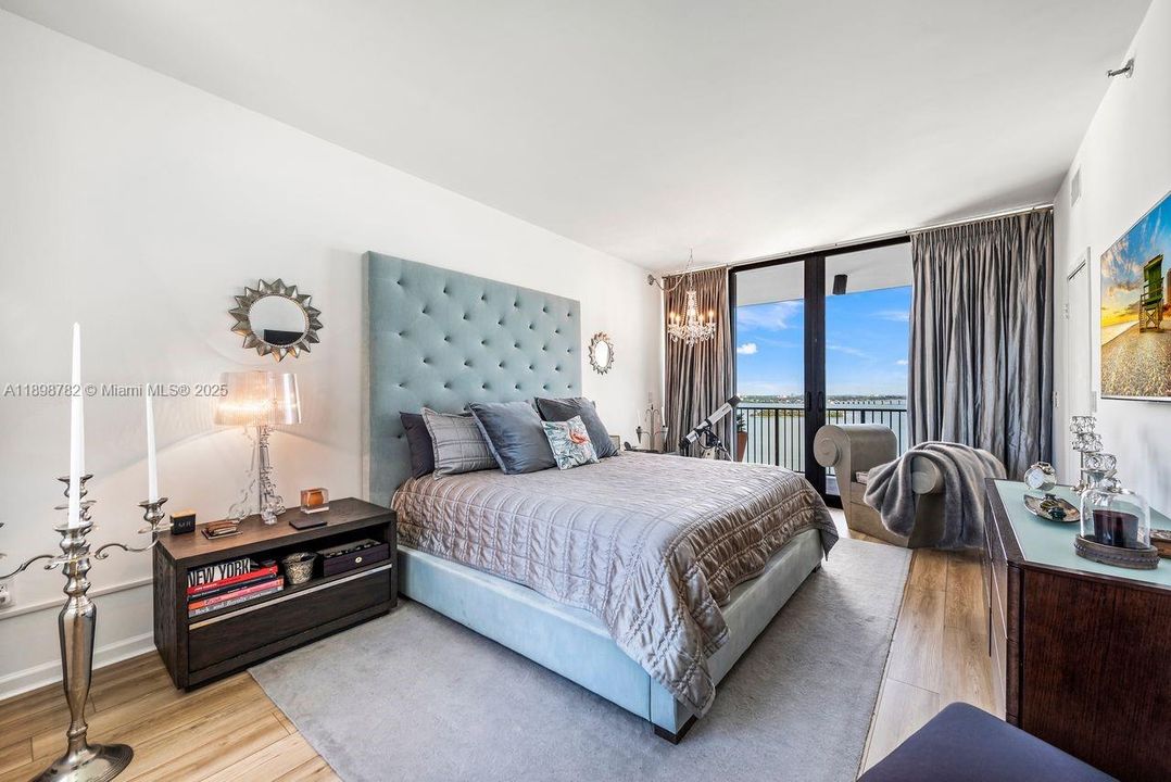Main Bedroom facing north with impact floor to ceiling sliding glass door to balcony