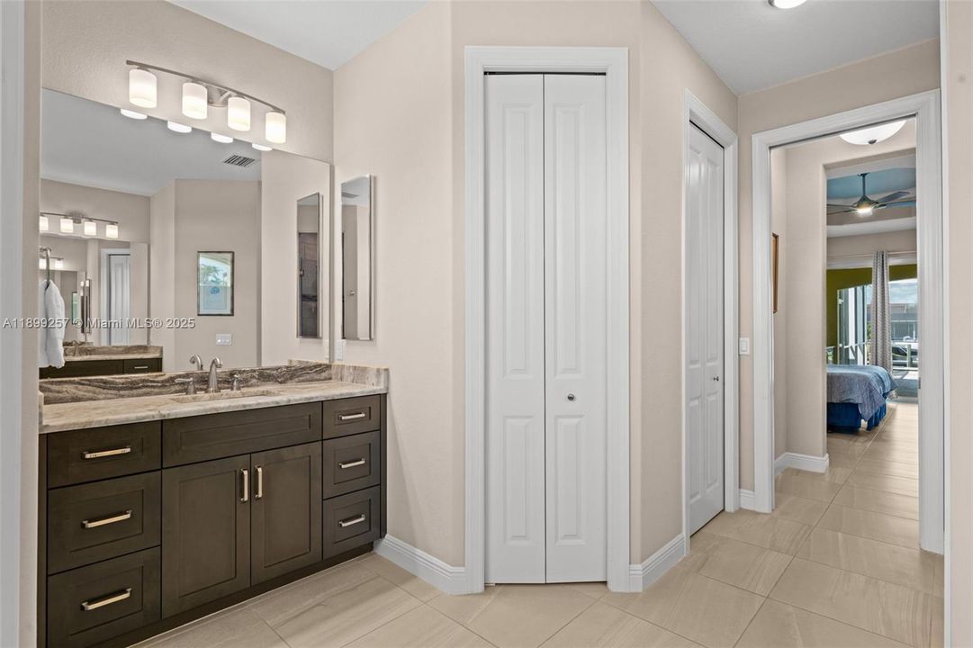 Master bath with dual vanities and a walk-in closet