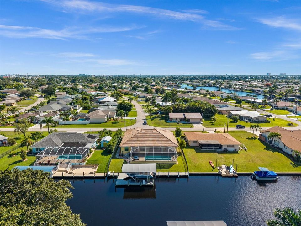Aerial view from the back with the boat lift and pool