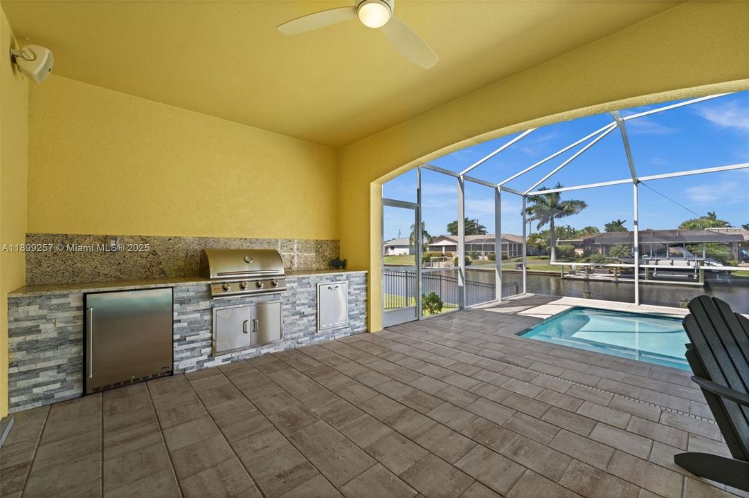 Outdoor kitchen in the covered lanai, all poolside!
