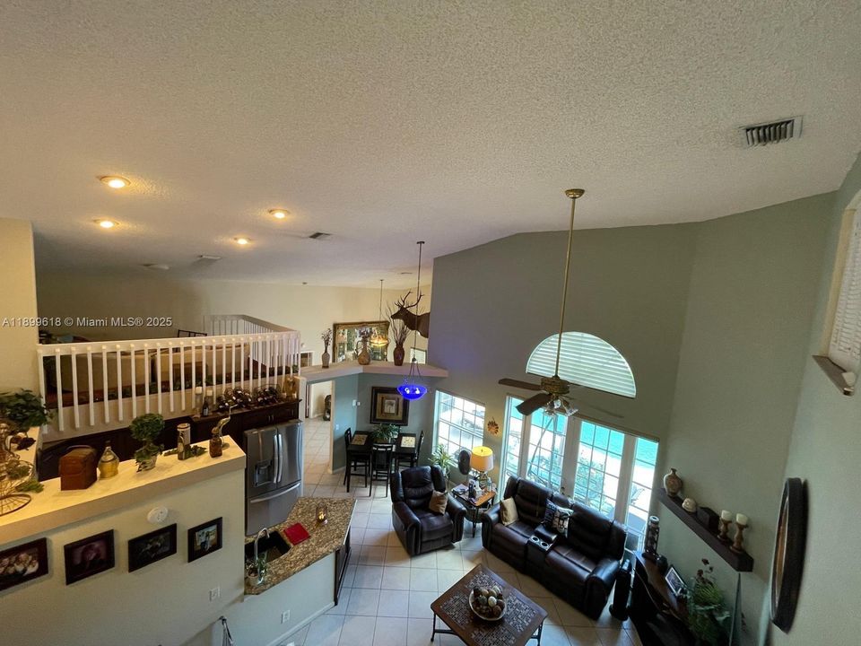 View of open layout and loft over dining room.