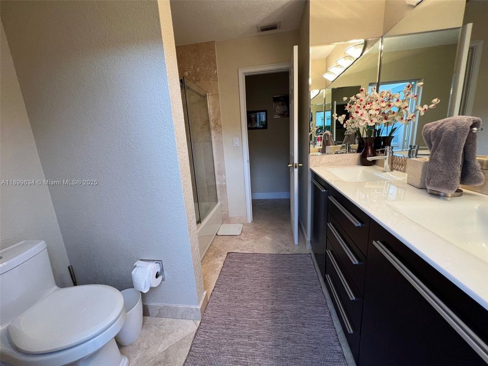 Main bathroom with granite countertop and double sinks