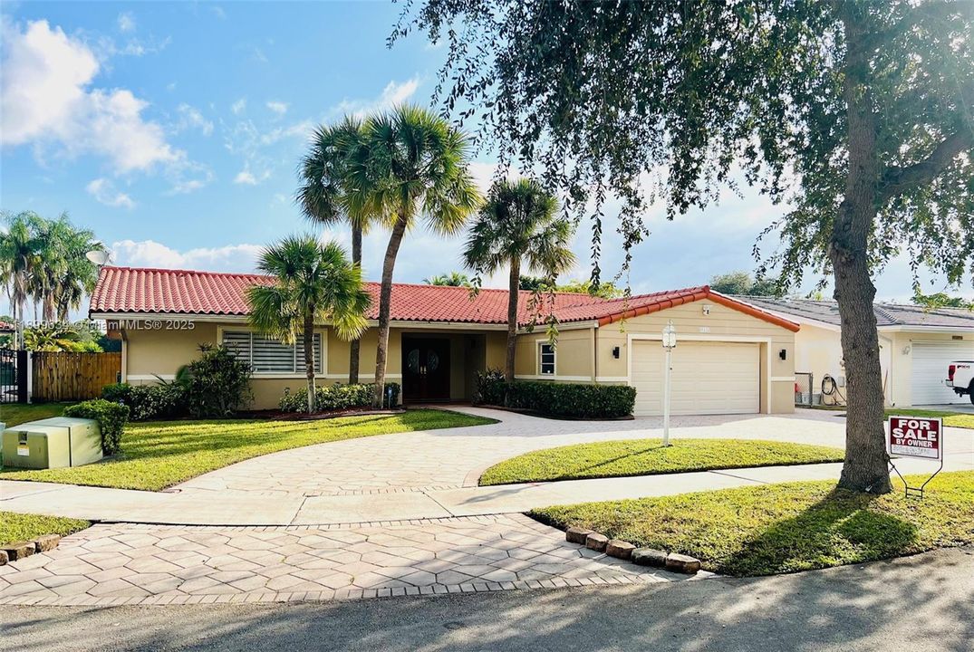 Front of house has circular driveway with brick pavers.  Garage door is hurricane-proof and insulated, mini-split AC in garage (garage has not been closed in)