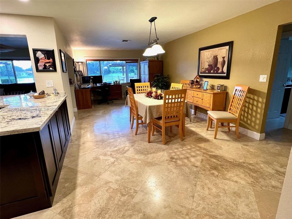 Informal dining area and home office space overlooking pool and lake