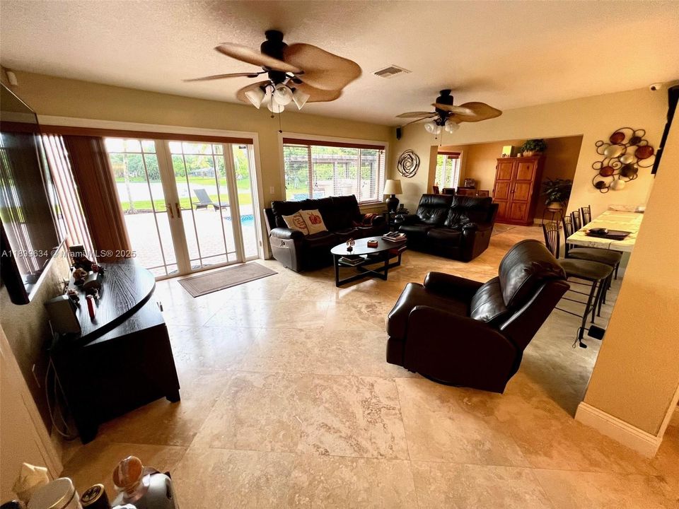 Large family room with view of lake and pool
