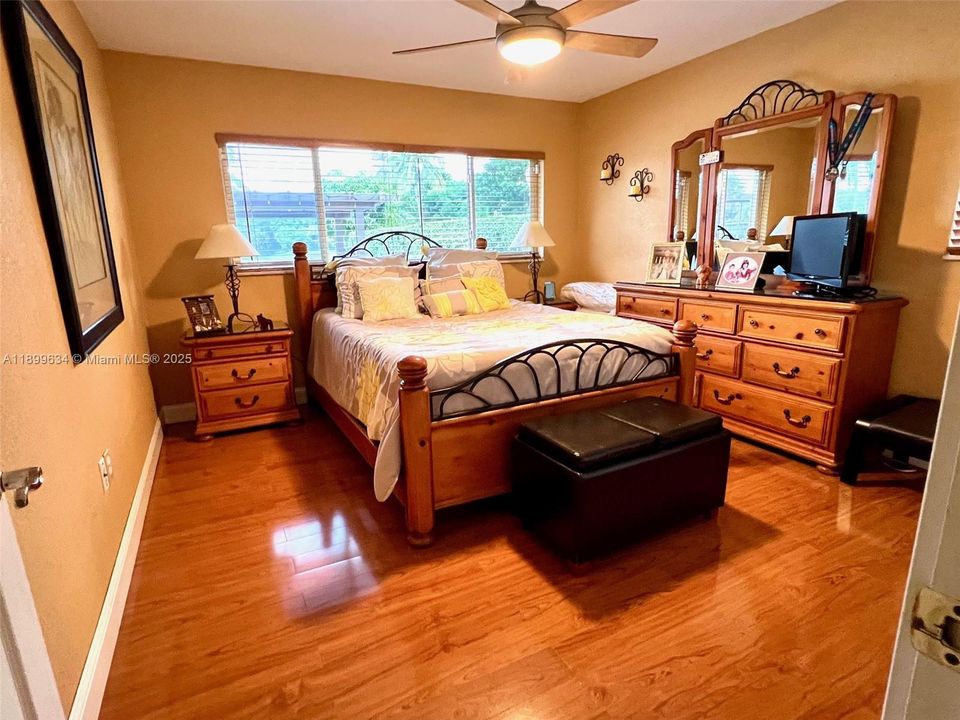Bedroom #2 has a view of the lake, ceiling fan and wall-to-wall closet
