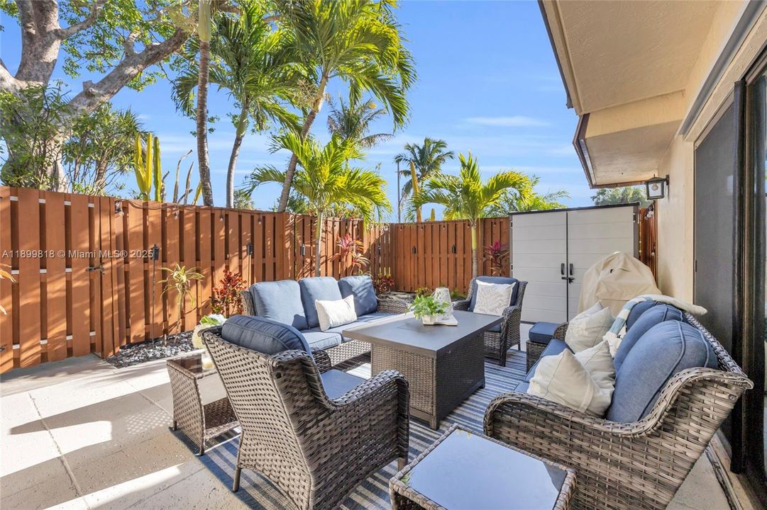 Large outdoor entertaining space with storage shed