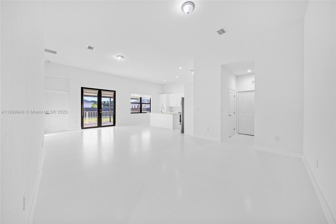 Great Room (view of dining, living, kitchen, door to 1/2 bath and laundry)