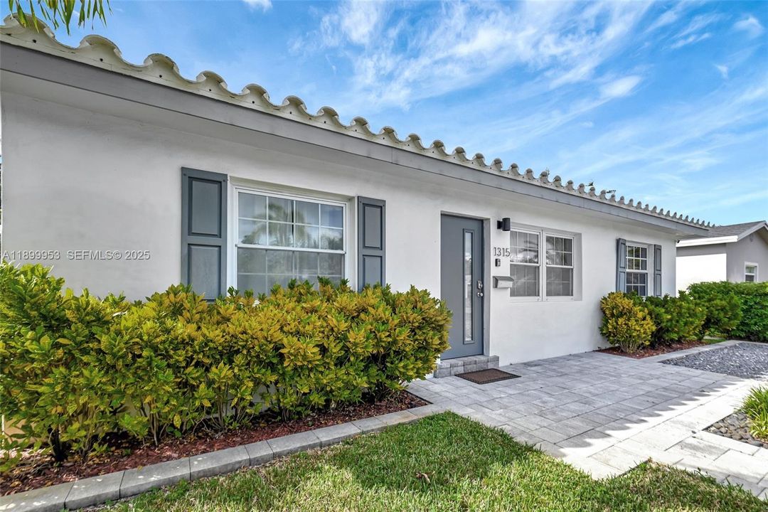 Beautiful and inviting entryway with a sleek modern façade and well-kept landscaping that enhances the home’s curb appeal.