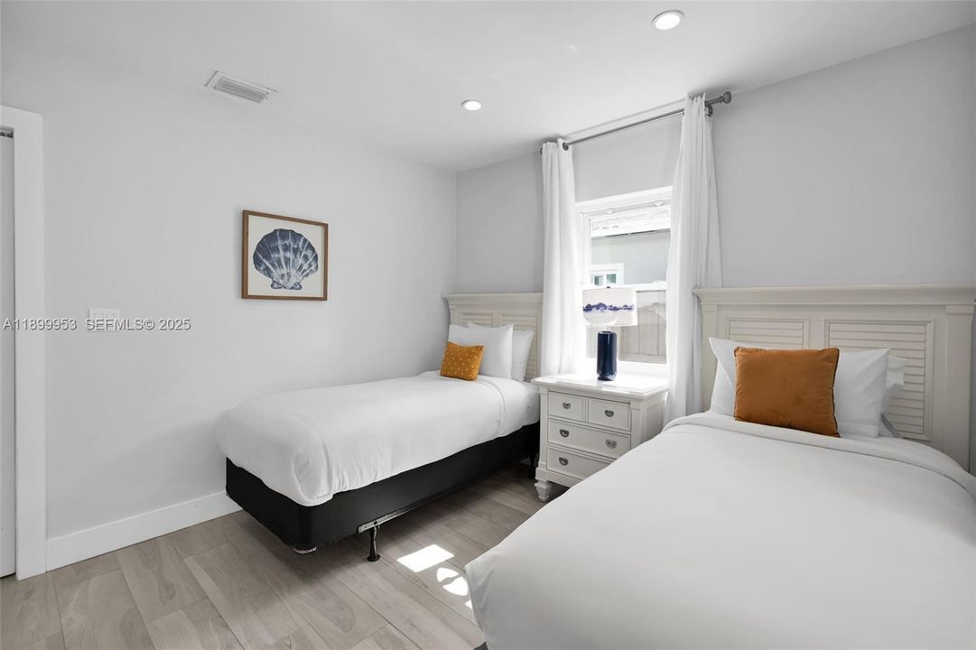 Versatile bedroom that can easily serve as a guest room, office, or reading nook.