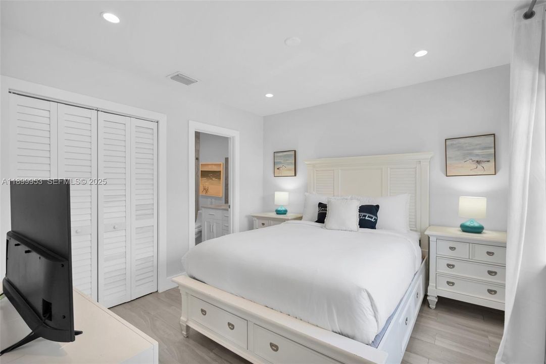 Bright and airy guest bedroom with generous closet space and stylish décor.