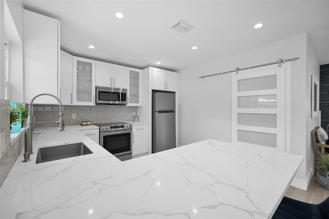 Spacious kitchen layout offering easy movement, abundant counter space, and a perfect setup for cooking and entertaining.