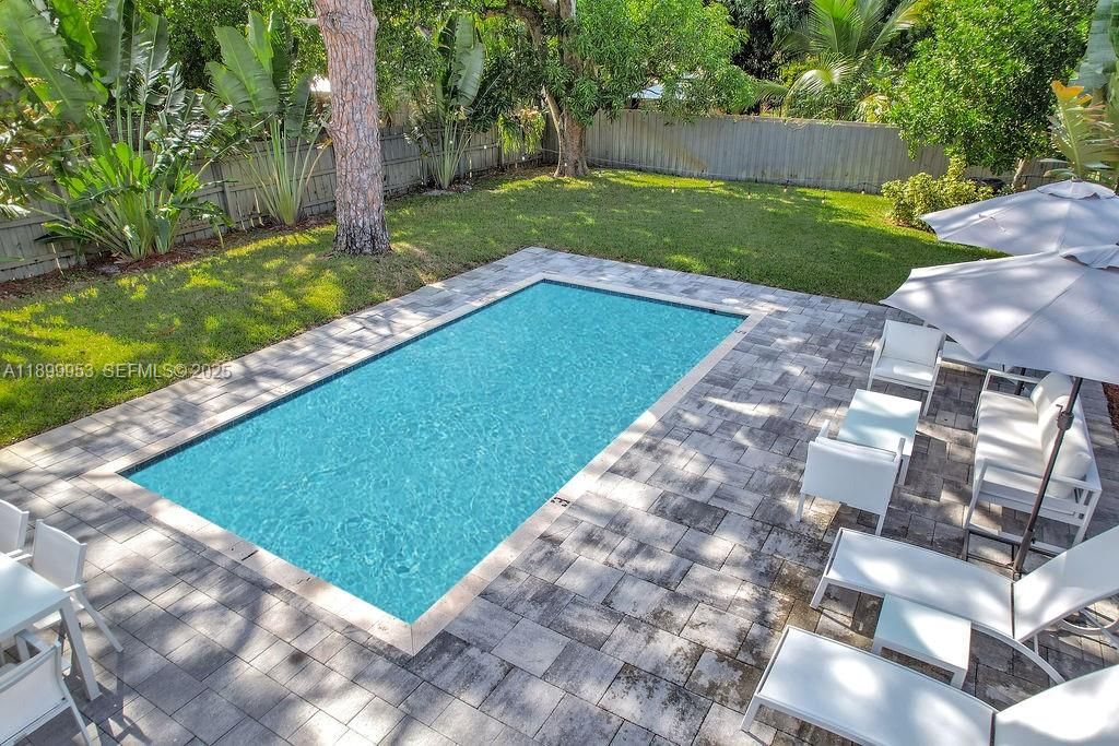 Peaceful pool area surrounded by greenery — the ultimate private oasis for outdoor living.