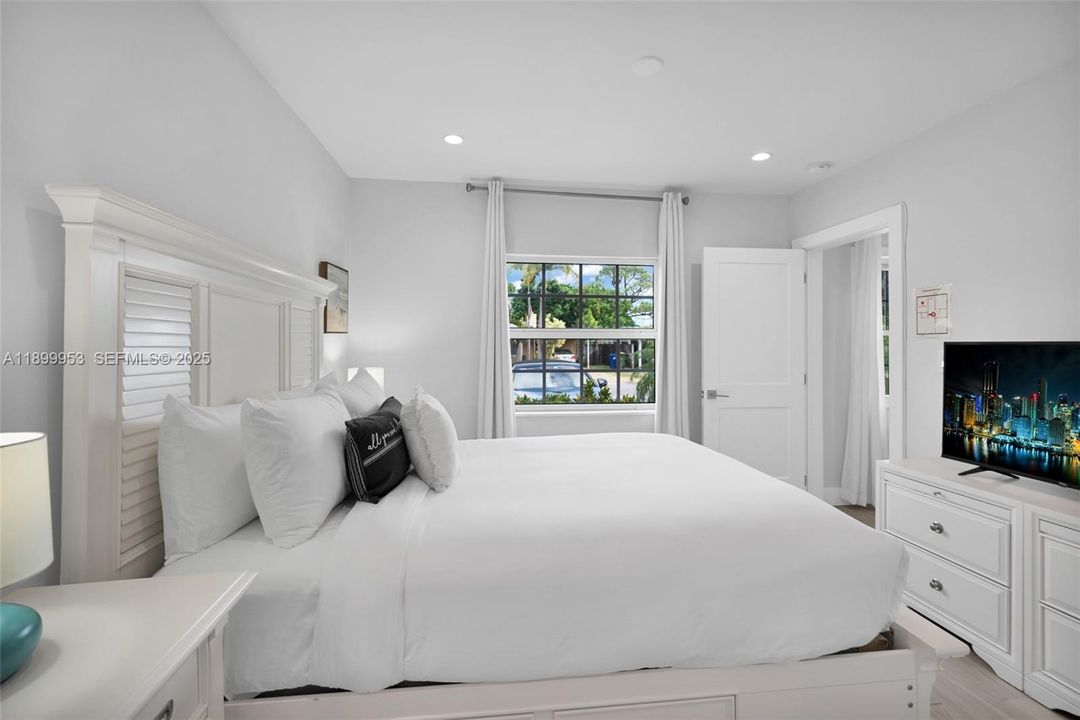 Tranquil primary bedroom offering space, comfort, and a serene view — your perfect retreat after a long day.