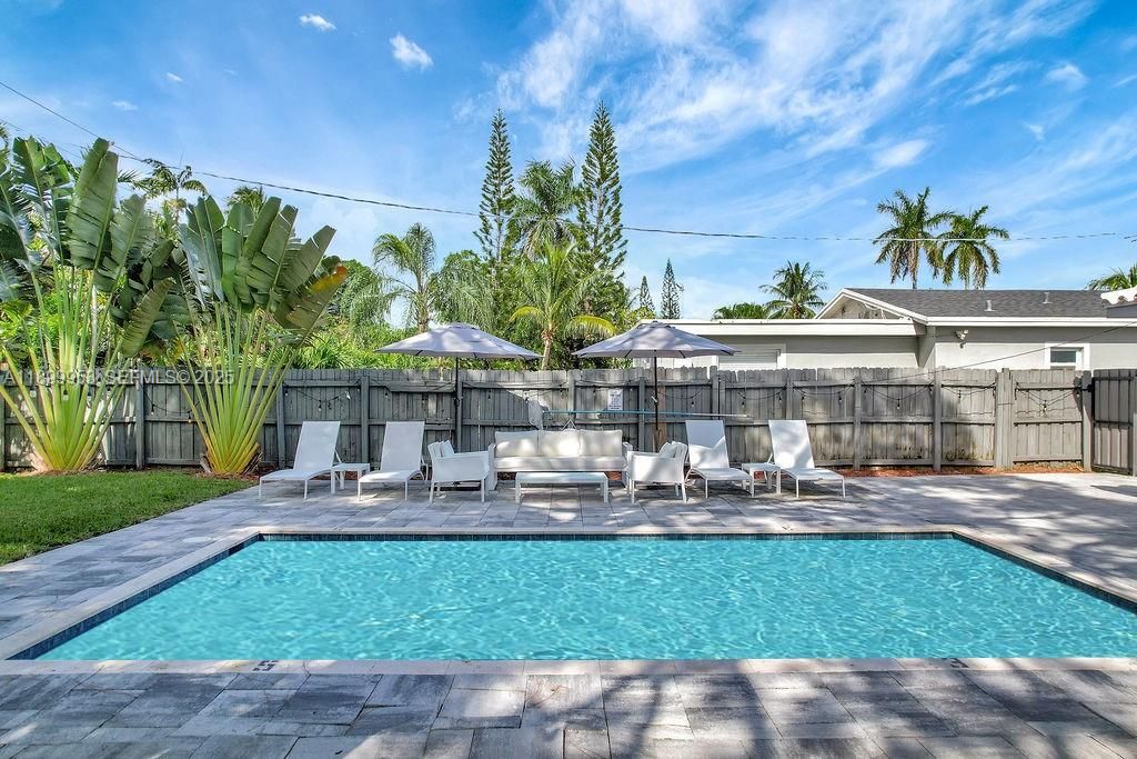 Resort-style pool area offering a serene and spacious outdoor escape with a perfect balance of sun and shade.