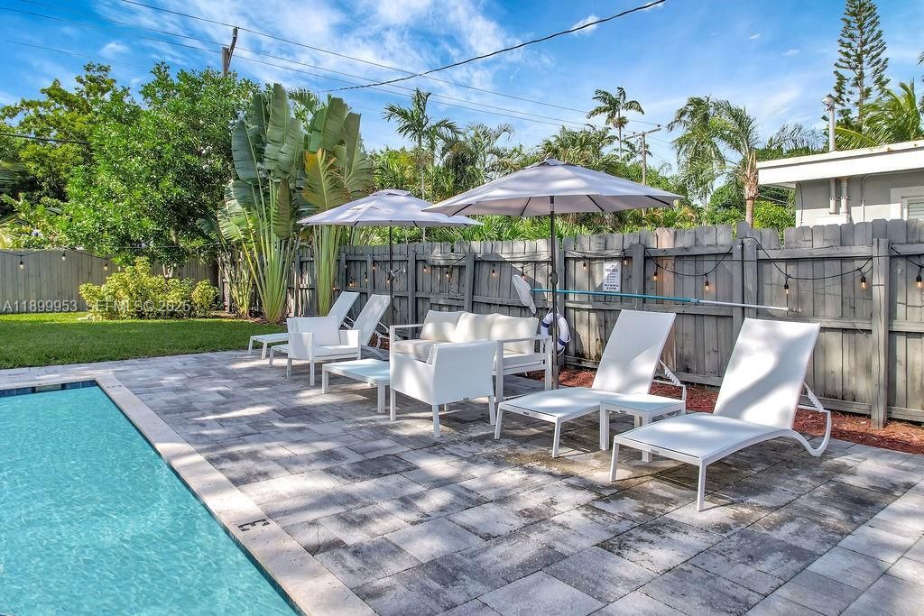 Charming outdoor patio area with comfortable seating — ideal for al fresco dining and entertaining.