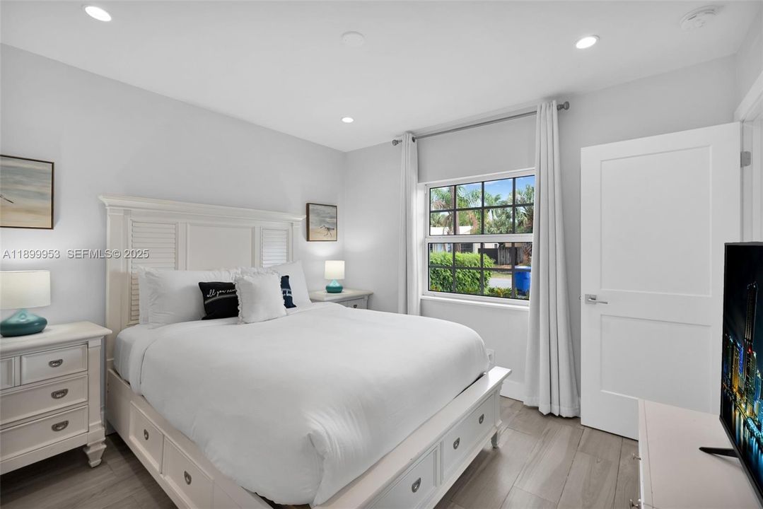 Inviting bedroom with natural light and a cozy, relaxing atmosphere.