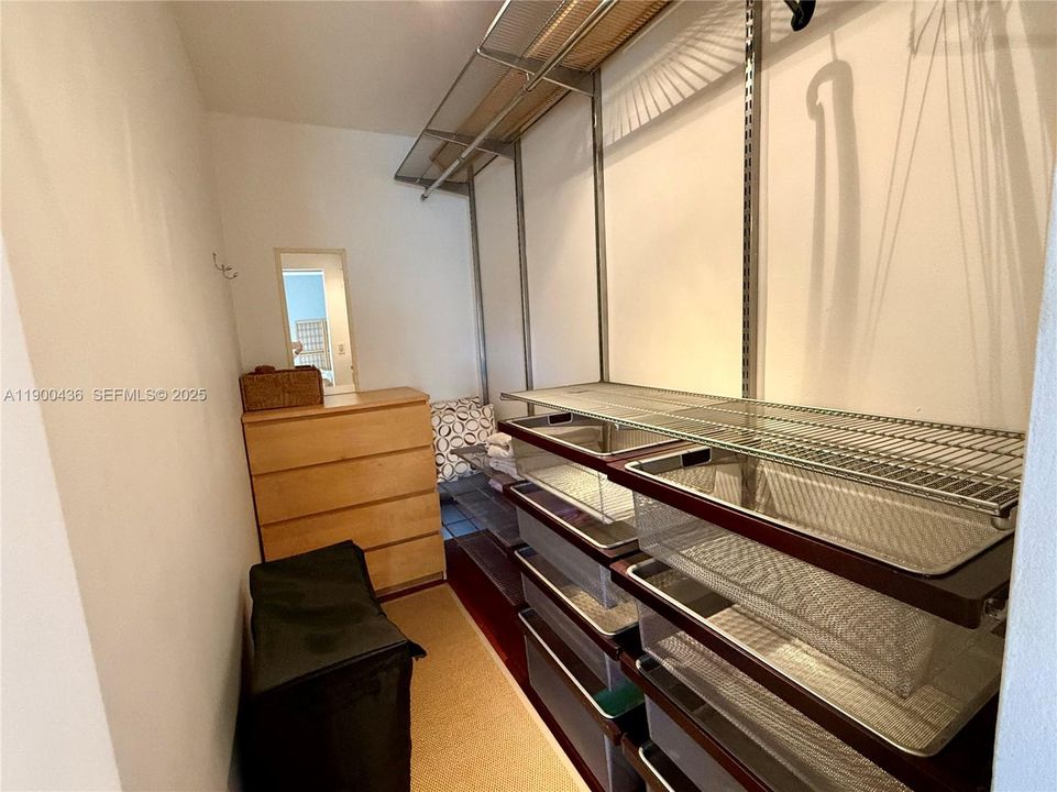 Walk in closet with organized shelves & drawers