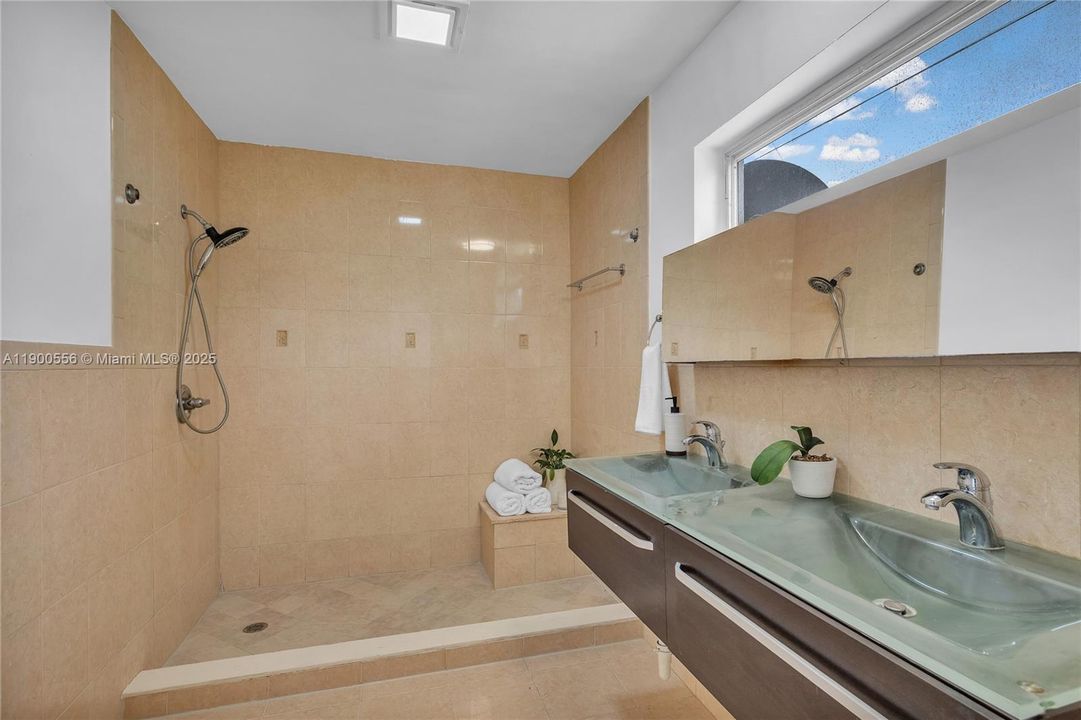 Main Bathroom with 2 sinks and a spacious shower.