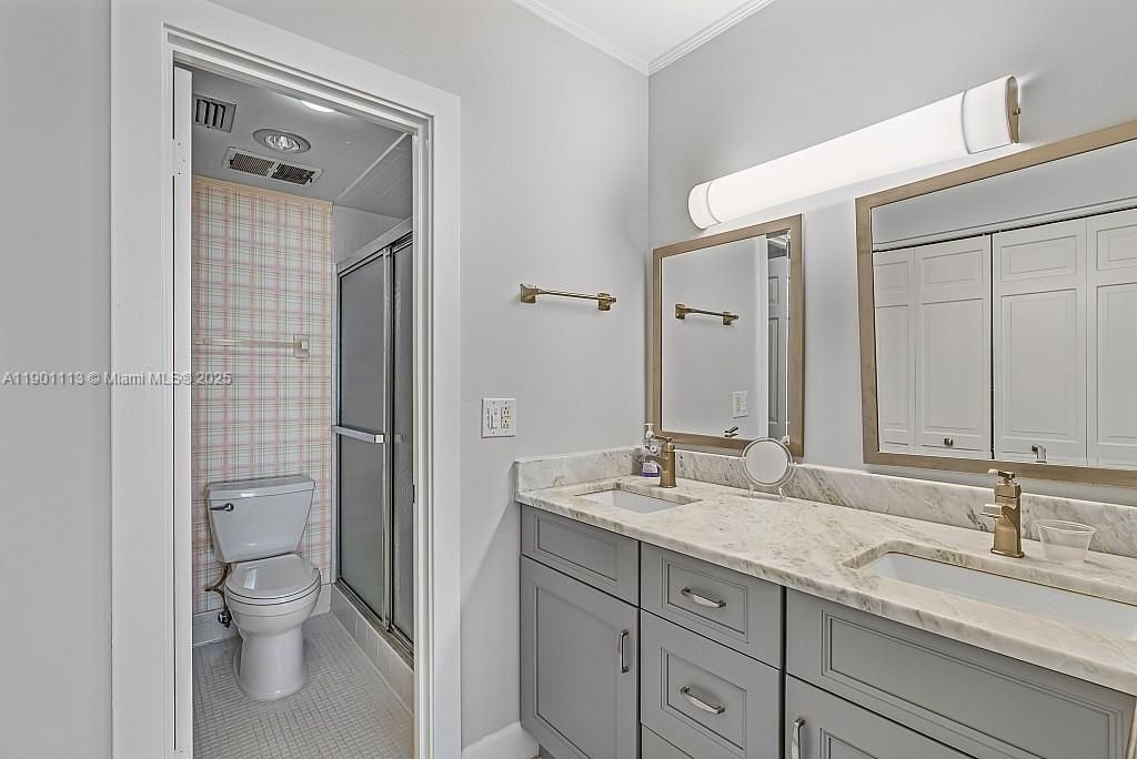 Primary Bath dual vanities is light and bright.