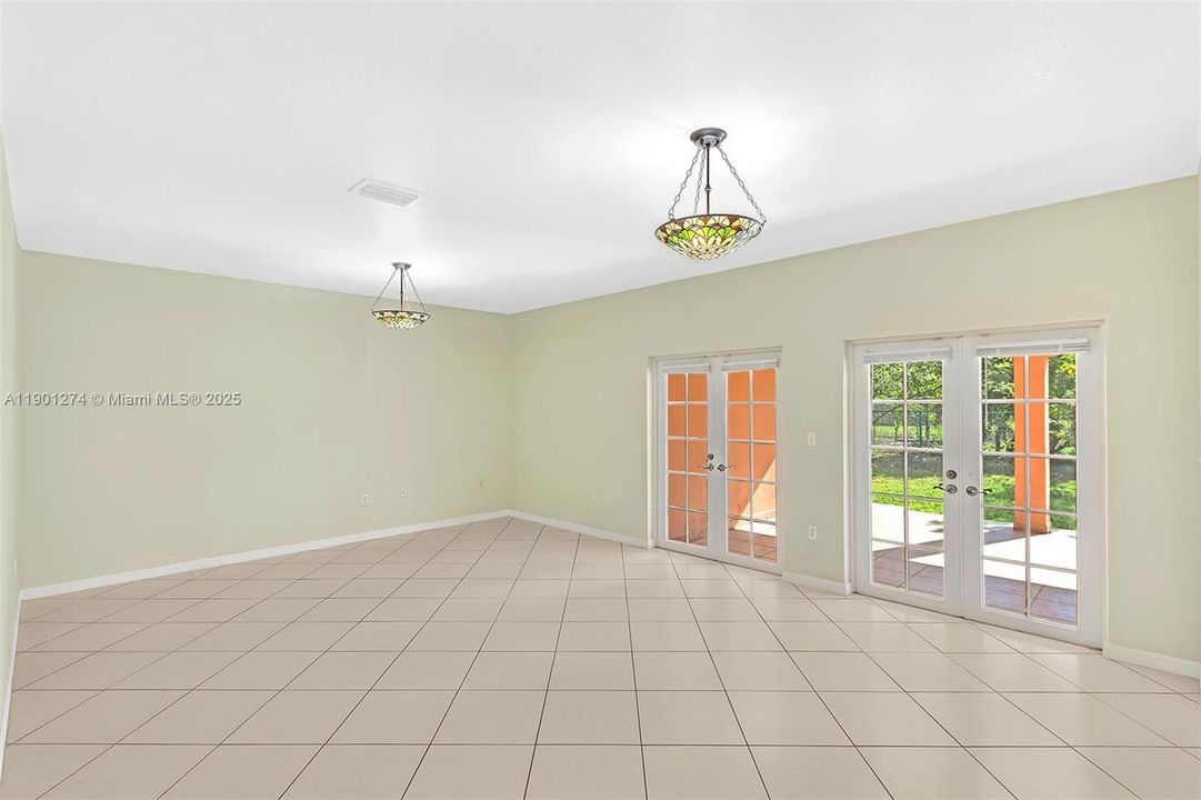 This family room is perfect for entertaining, it opens to an expansive covered terrace and backyard.