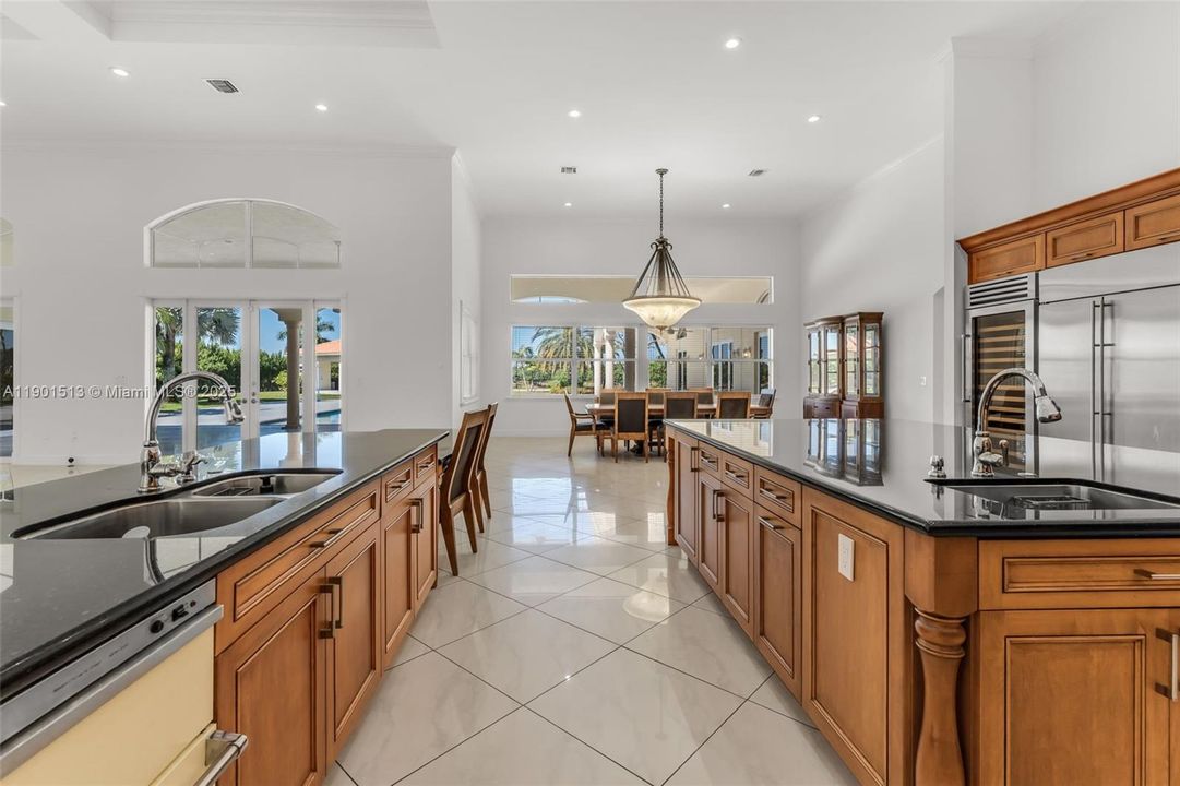 DINE IN CHEFS KITCHEN WITH DOUBLE ISLANDS. EQUIPPED WITH ALL HI END APPLIANCES TO INCLUDE THE VIKING LINE. with dining overlooking pool patio