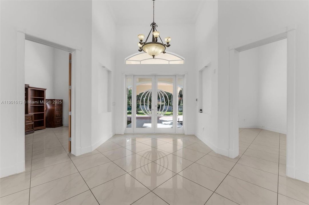 OFFICES ON BOTH SIDES OF FOYER A TOTAL OF 4. THE PORTE COCHERE PROVIDES COVERAGE FOR ALL TYPES OF WEATHER, THERE IS A DOUBLE AND TRIPLE GARAGE ON EACH WING WITH INTERIOR ACCESS THERE IS ANOTHER SIDE ENTRY WHICH PROVIDES ACCESS TO THE MEDIA WING.